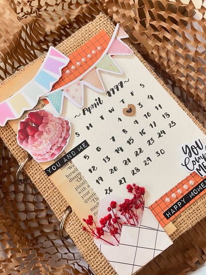 The details are what make it special. This scrapbook cover includes little banners, cake stickers, and a tiny envelope with dried flowers, all coming together to create a piece of art.