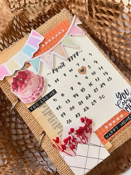 The details are what make it special. This scrapbook cover includes little banners, cake stickers, and a tiny envelope with dried flowers, all coming together to create a piece of art.