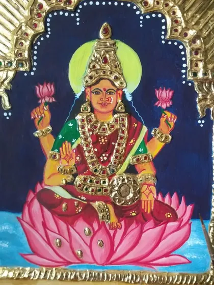 A full, clear view of the completed Mahalakshmi Tanjore painting. The goddess is depicted in rich jewel tones, seated on a pink lotus, embodying grace and prosperity.