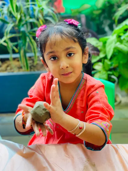 Getting hands-on with clay is one of our most popular activities. This young artist is completely absorbed in sculpting her Ganesha idol during one of our festive workshops, a perfect example of our tactile, engaging art experiences.