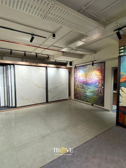 Another view of the Mysore Road showroom, highlighting the variety of large-scale tile displays. Here you can see marble-look vitrified tiles next to vibrant, artistic landscape and abstract murals, showcasing the breadth of my collection.