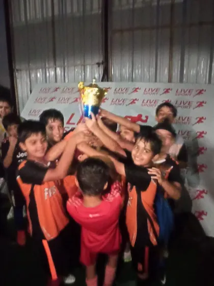 The moment of celebration for our U9 team as they lift the championship trophy at the Junior League.