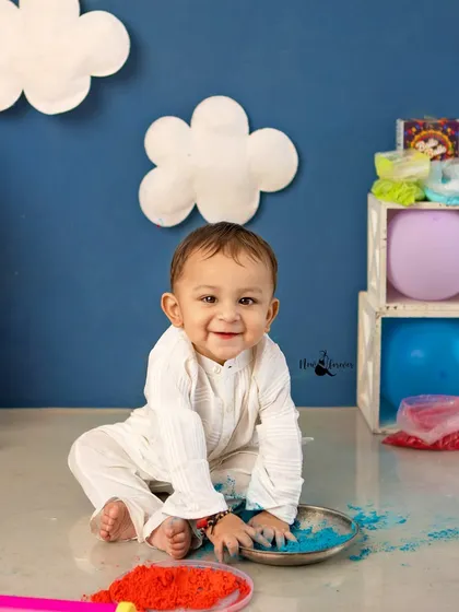 A bright, happy smile from a boy playing with red and blue colors. These sessions are all about capturing genuine laughter and fun.