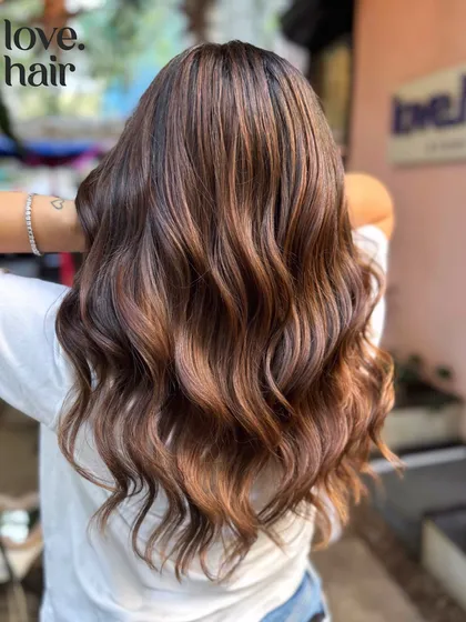The full effect of the 'Mocha Girl Flow' from the back. It's a perfect example of a natural, sun-kissed brunette look.