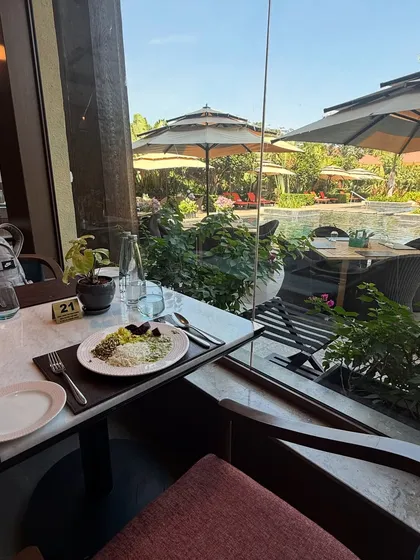 A wholesome meal enjoyed with a view of a tranquil pool and lush greenery. We believe that nourishing the body is a key part of nourishing the soul.