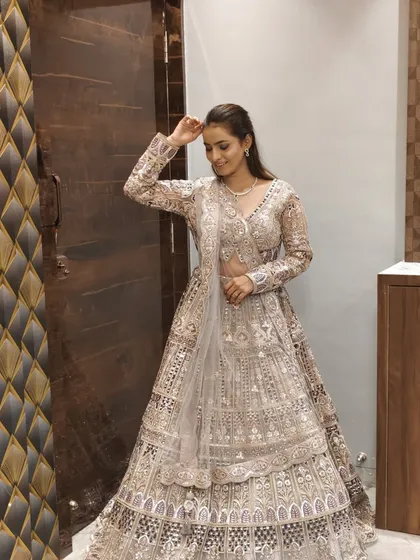 A candid shot of the client in the grey and silver lehenga.