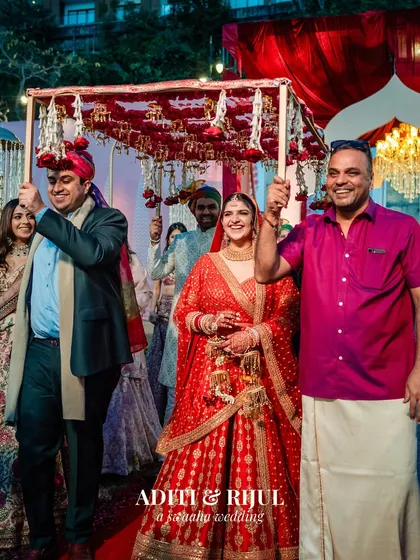 The bride's processional, escorted by her brothers under a beautiful floral 'phoolon ki chadar'.