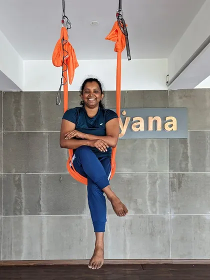 A happy student enjoying the supportive comfort of the aerial hammock at our Bangalore studio.