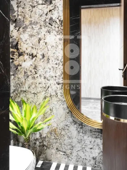 The gold-framed mirror and unique pedestal sink are the heroes of this powder room. These elements, combined with the striking marble and flooring, create a space that is full of character.
