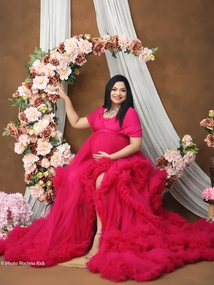 A stunning solo portrait featuring our pink ruffled gown and a beautiful floral arch. This setup is perfect for creating a romantic, fairytale-inspired photoshoot.