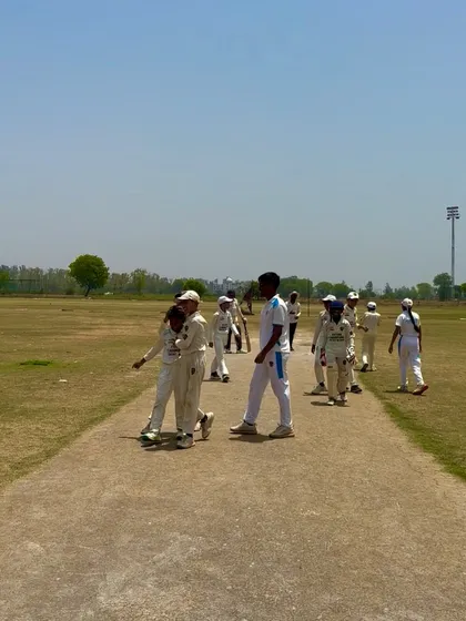 The team celebrates another wicket taken by their star bowler.