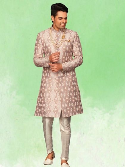 This mauve sherwani with a geometric pattern offers a unique color and design. Paired with a pearl necklace, it creates a soft yet regal look.