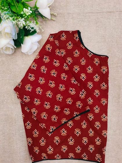 A maroon cotton boatneck blouse with a small, traditional block print.