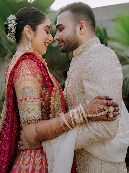 A close-up of the couple's embrace, filled with love and happiness. Their smiles and the way they look at each other tell their entire love story.