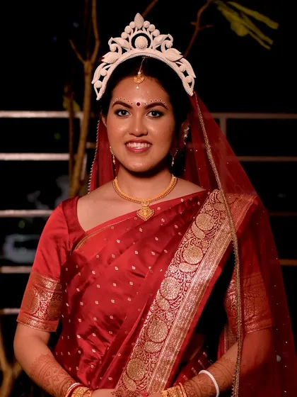 A full-length shot of the bride, looking serene and beautiful. The makeup is subtle, ensuring she looks like herself on her special day.