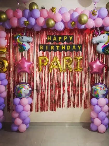 A centered view of the Unicorn theme birthday setup, highlighting the name and age balloons.