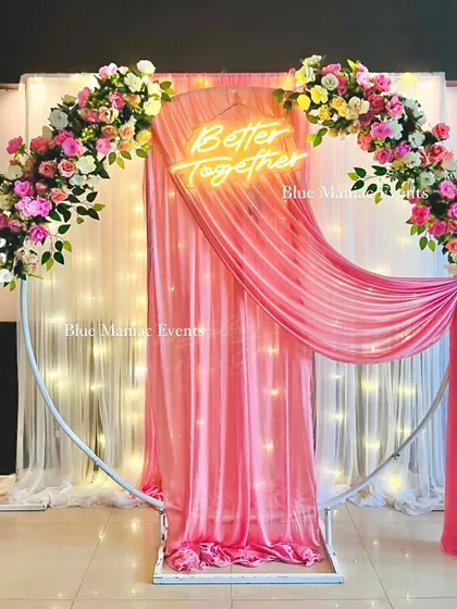 The same pink-themed Roka backdrop shown without the sofa, highlighting the full ring frame and the elegant draping. This is a versatile piece for various events.