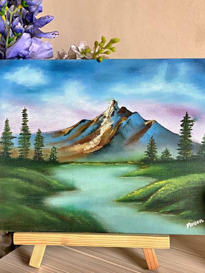 A tranquil mountain landscape painted on a small canvas. These mini-paintings are perfect for desks or shelves, bringing a little piece of heaven into your space.
