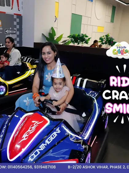 Ride, crash, smile, and repeat! A mother and daughter are all set for their bumper car adventure, complete with a party hat. It's the perfect way to add some thrill to any celebration.