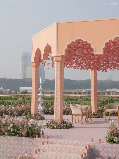 The mandap stage, with its custom-printed pink floor and a canopy of flowers, creating a space that is both grand and romantic.