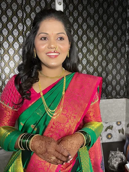 A happy, smiling bride. The makeup enhances her natural features beautifully.