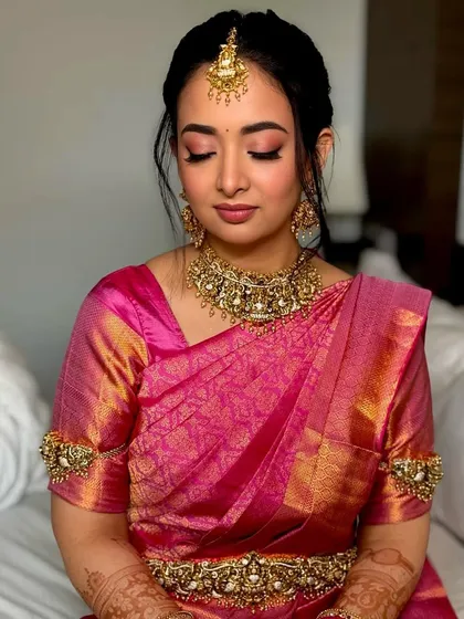 A close-up with eyes closed, showcasing the beautifully blended pink and gold eyeshadow. This look is soft, romantic, and perfectly suited for a South Indian bride.