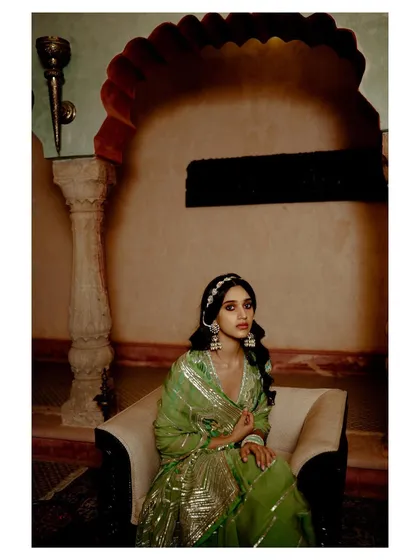 A framed portrait for Ruhr India, featured on PhotoVogue. The composition uses architectural elements and deep shadows to create a moody and elegant setting for the traditional attire.