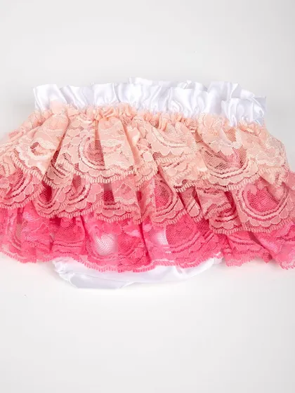 A product shot of the ruffled lace diaper cover in shades of pink and peach.