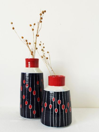 This set of two 'Dew Drops' vases comes in different sizes that complement each other perfectly. They can be used for dried flowers or stand alone as sculptural art pieces.