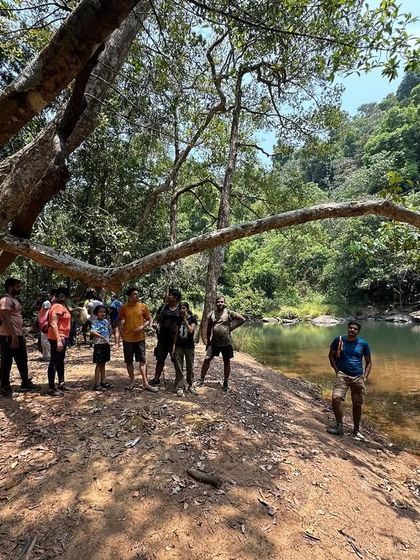 A group photo by the river, a memory from our summer camping and trekking trip.