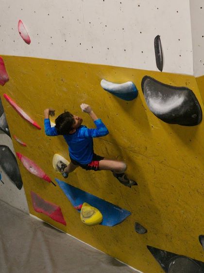 Even our young climbers get in on the action. Here, a young athlete tackles a difficult problem with impressive technique.