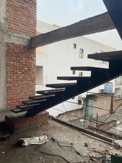 A side profile of the cantilevered staircase, emphasizing the clean, sharp lines and the engineering required to make the steps appear to float.