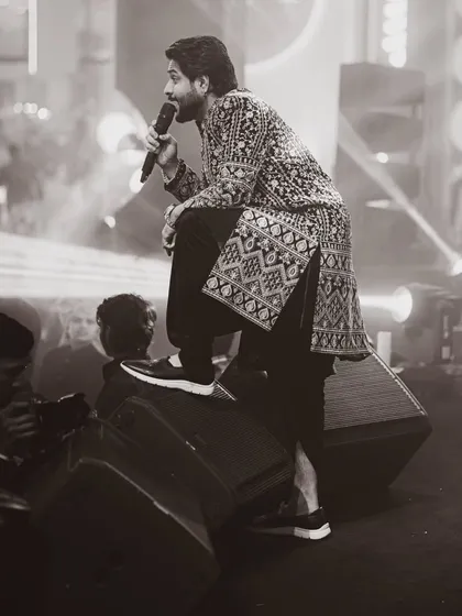 A candid, black and white moment on stage, connecting with the music on a deeper level.