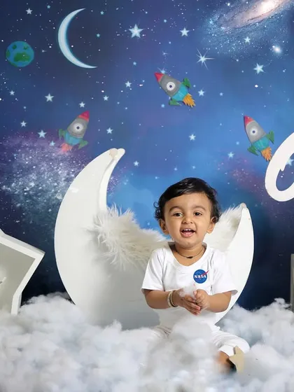 A little astronaut ready for takeoff. This space-themed shoot is perfect for adventurous little ones, complete with a moon, stars, and rockets.