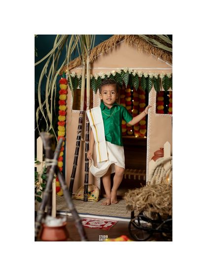 A full-length portrait of the little boy in our beautifully detailed Pongal hut set.