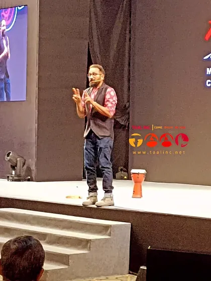 This is another angle of our facilitator leading a conference session. The djembe is on stage, ready to be used to anchor the rhythm and energize the room.