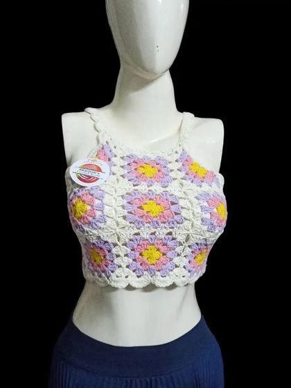 This is another version of my popular daisy granny square top, this time in a soft palette of white, lilac, and yellow. Each square is carefully joined to create this beautiful floral pattern.