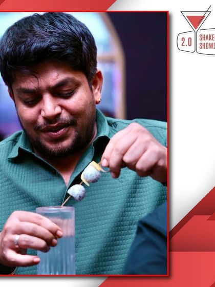 A competitor carefully adding a garnish during the competition. Every detail counts when you're aiming for the top spot.