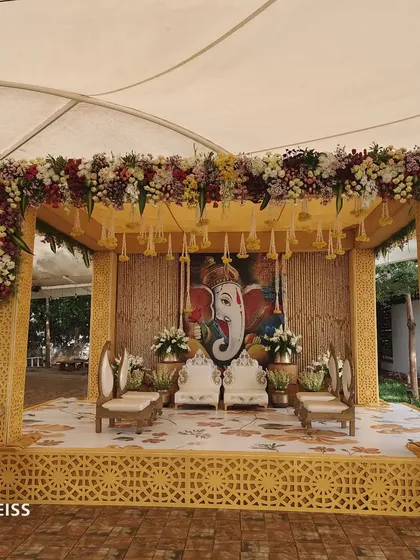 Our customized decor service allows for unique mandap designs, like this one featuring a Ganesha painting as the backdrop, blending art with sacred traditions.