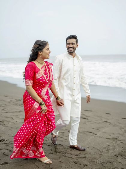 Walking together by the sea. These moments of movement and connection make for beautiful, dynamic pre-wedding photos.