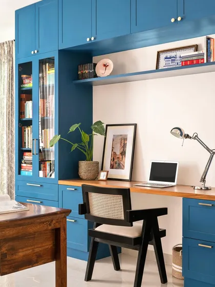 A home office doesn't have to be purely functional. We used a bold mineral blue for this custom library and desk unit, creating an inspiring space for work that is filled with character and ample storage.