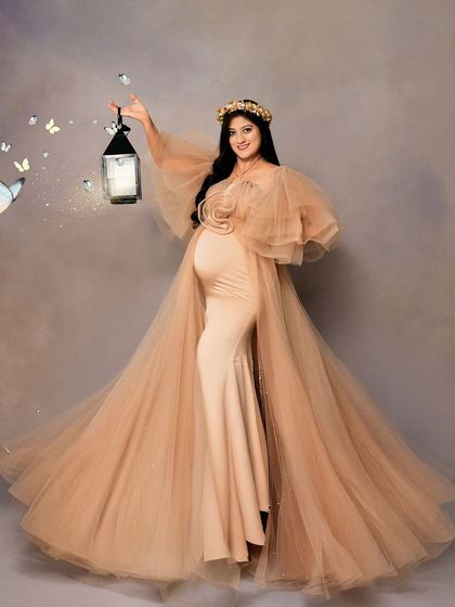 A whimsical solo portrait featuring a beige ruffled gown and a lantern with magical butterfly effects. This shot combines elegance with a touch of fairytale magic.
