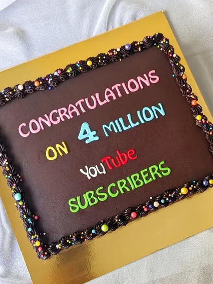 A simple yet impactful chocolate sheet cake to celebrate a YouTuber reaching 4 million subscribers. This shows how a straightforward design can be customized to celebrate modern digital milestones for creators and brands.