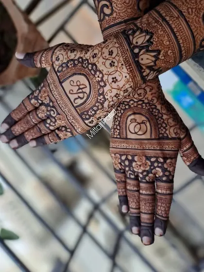 A close-up of the engagement design, showing the intricate floral and geometric patterns surrounding the personalized initials.