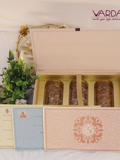 This sophisticated pastel pink box contains three jars of gourmet mixed nuts and is paired with a suite of matching wedding cards. The design is clean and modern, with a touch of traditional elegance in the monogram.