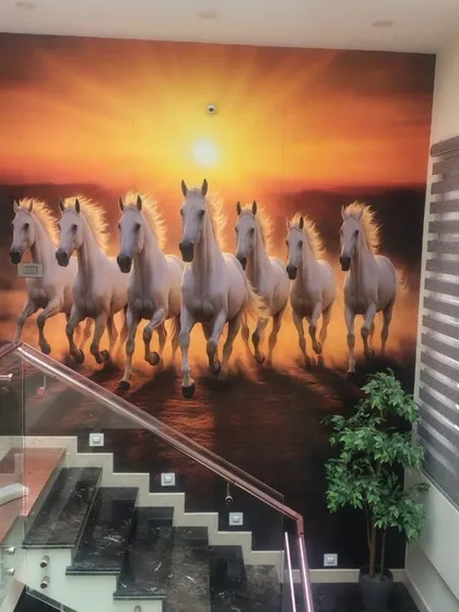 A powerful statement piece for a large wall. This custom mural of seven running horses, often associated with Vastu for success and power, was installed along a staircase. The vibrant sunset and dynamic motion create an unforgettable first impression in this home's entryway.