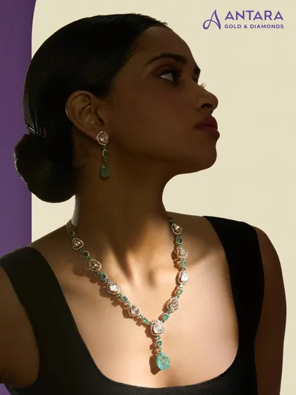 Here is a cascade of uncut polkis and green tourmaline accents, handcrafted in 14 kt gold. The necklace flows into a faceted drop, designed so that every detail shines with an inner light.