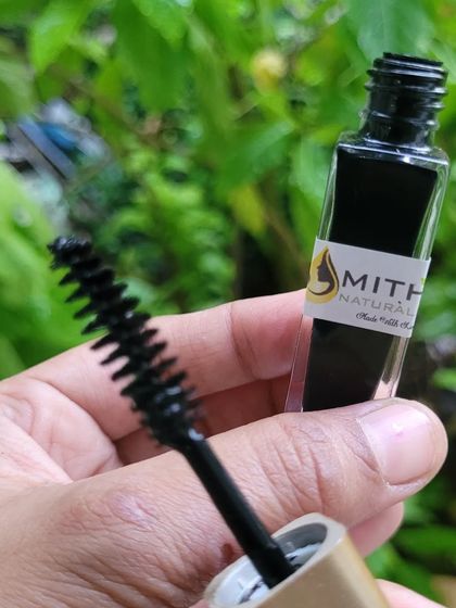 A detailed shot of the mascara wand and bottle. You can see the texture of the brush, which helps apply the natural formula smoothly.