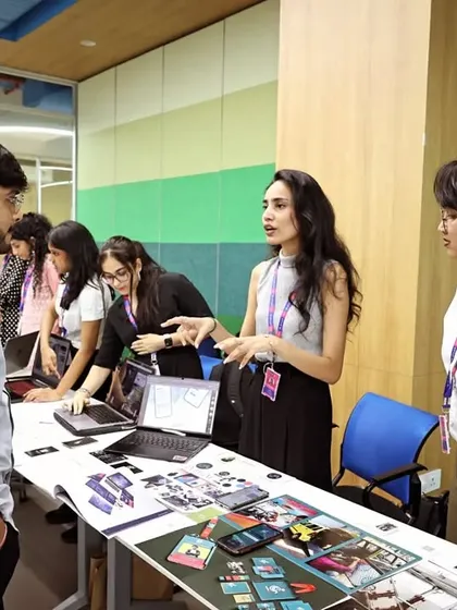 I enjoy helping the next generation of artists find their footing. In this photo, I'm reviewing a student's portfolio at Atlas Skilltech University, offering feedback to help them connect their creative projects with real-world industry expectations.