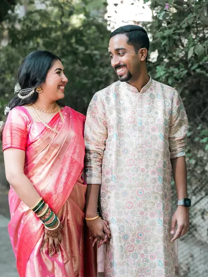 A happy couple holding hands and sharing a smile.